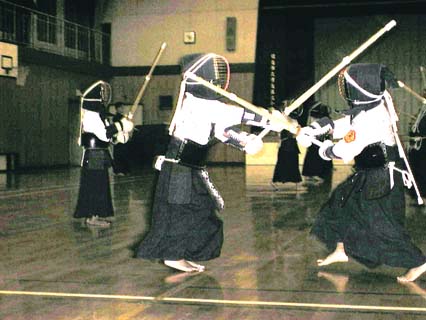 The clash of bamboo swords reverberates in the gymnasium. kendo clash